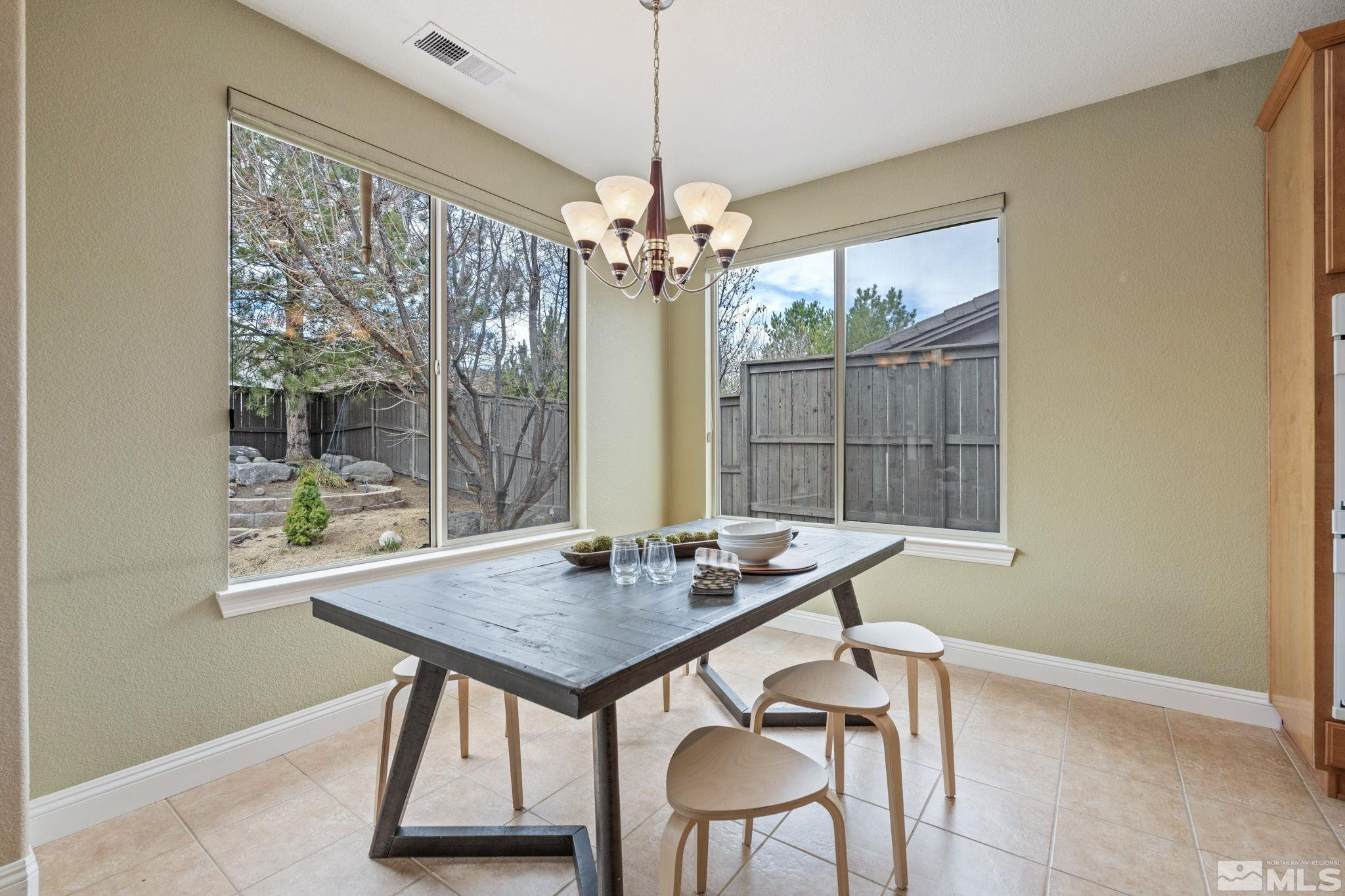 610 Aberdeen Court Reno, NV 89521 - Photo 16 of 40 a view of a dining room with furniture wooden floor and chandelier