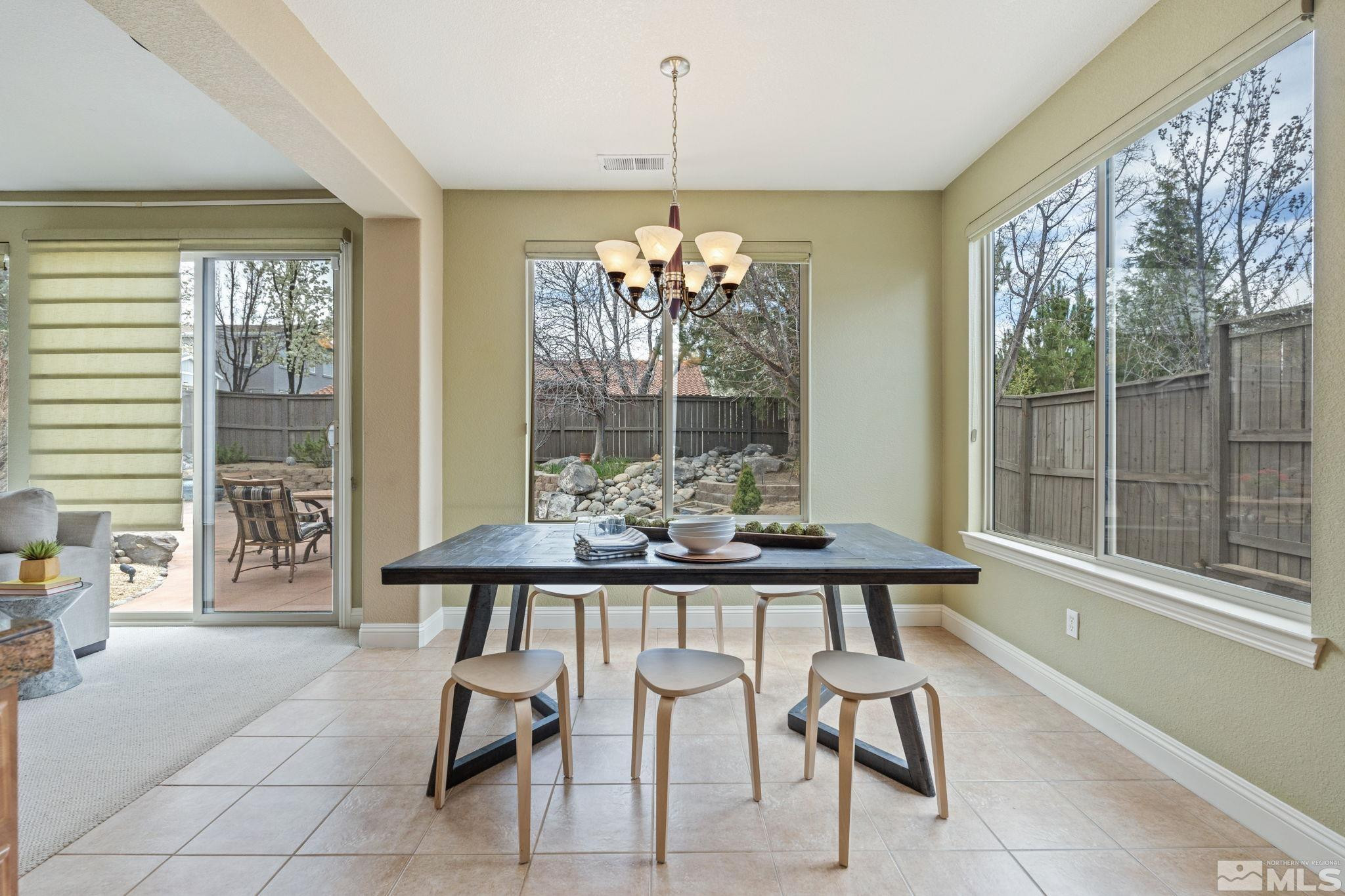 610 Aberdeen Court Reno, NV 89521 - Photo 20 of 40 a view of a dining room with furniture large windows and wooden floor