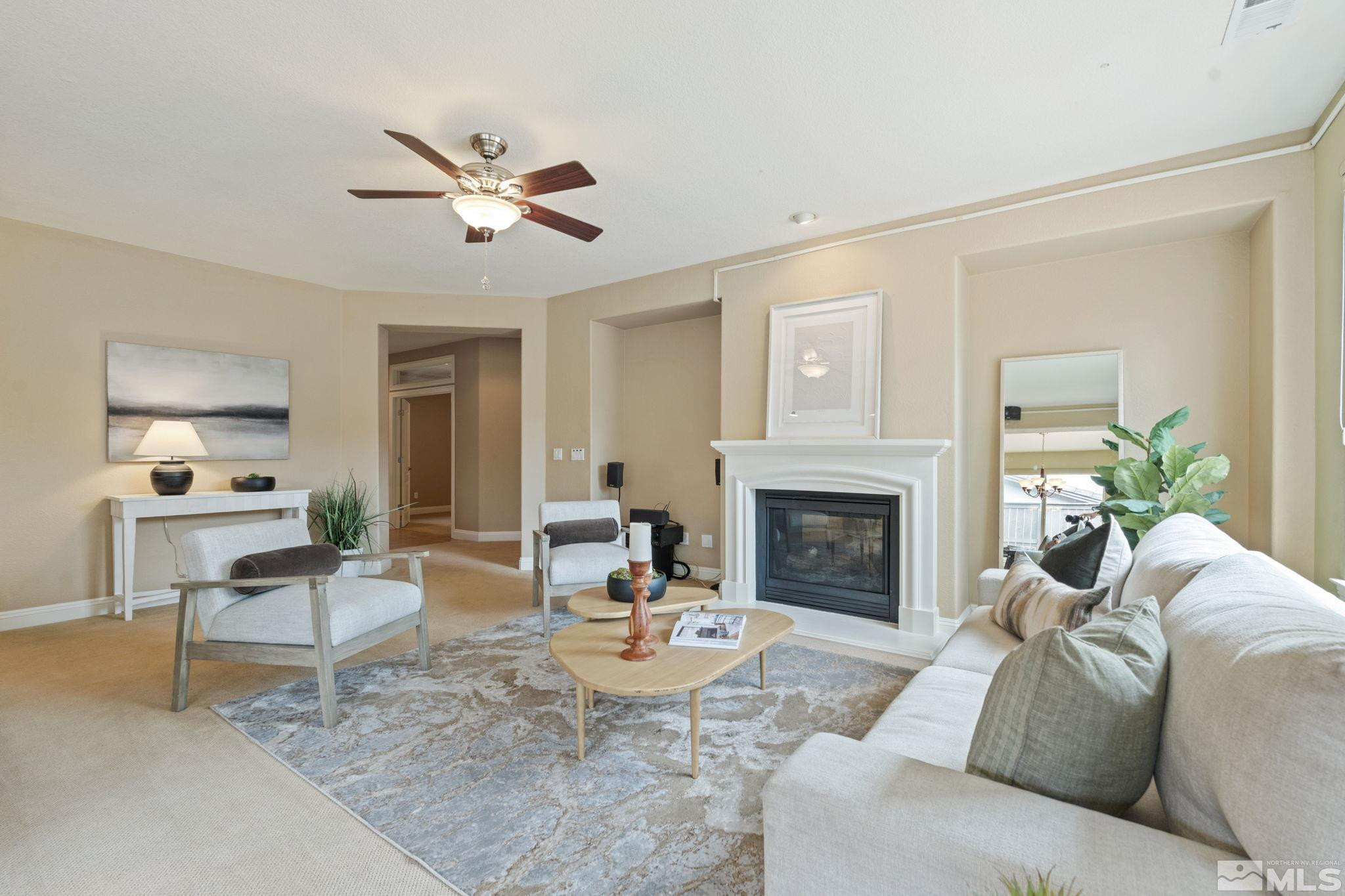 610 Aberdeen Court Reno, NV 89521 - Photo 2 of 40 a living room with furniture a fireplace and a ceiling fan