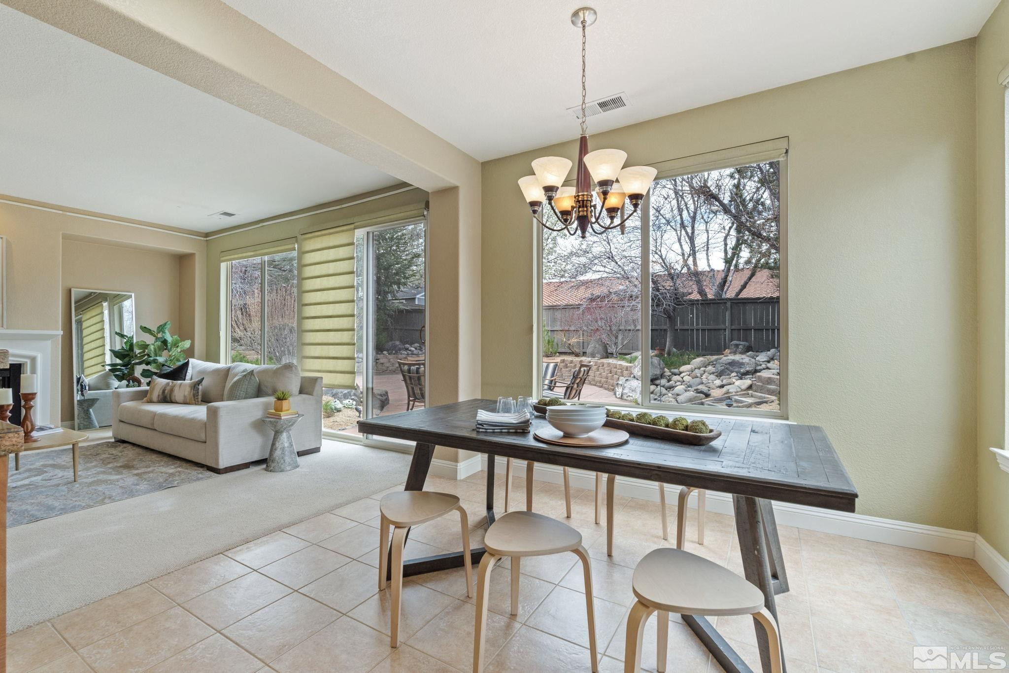 610 Aberdeen Court Reno, NV 89521 - Photo 21 of 40 a dining room with furniture a chandelier and wooden floor