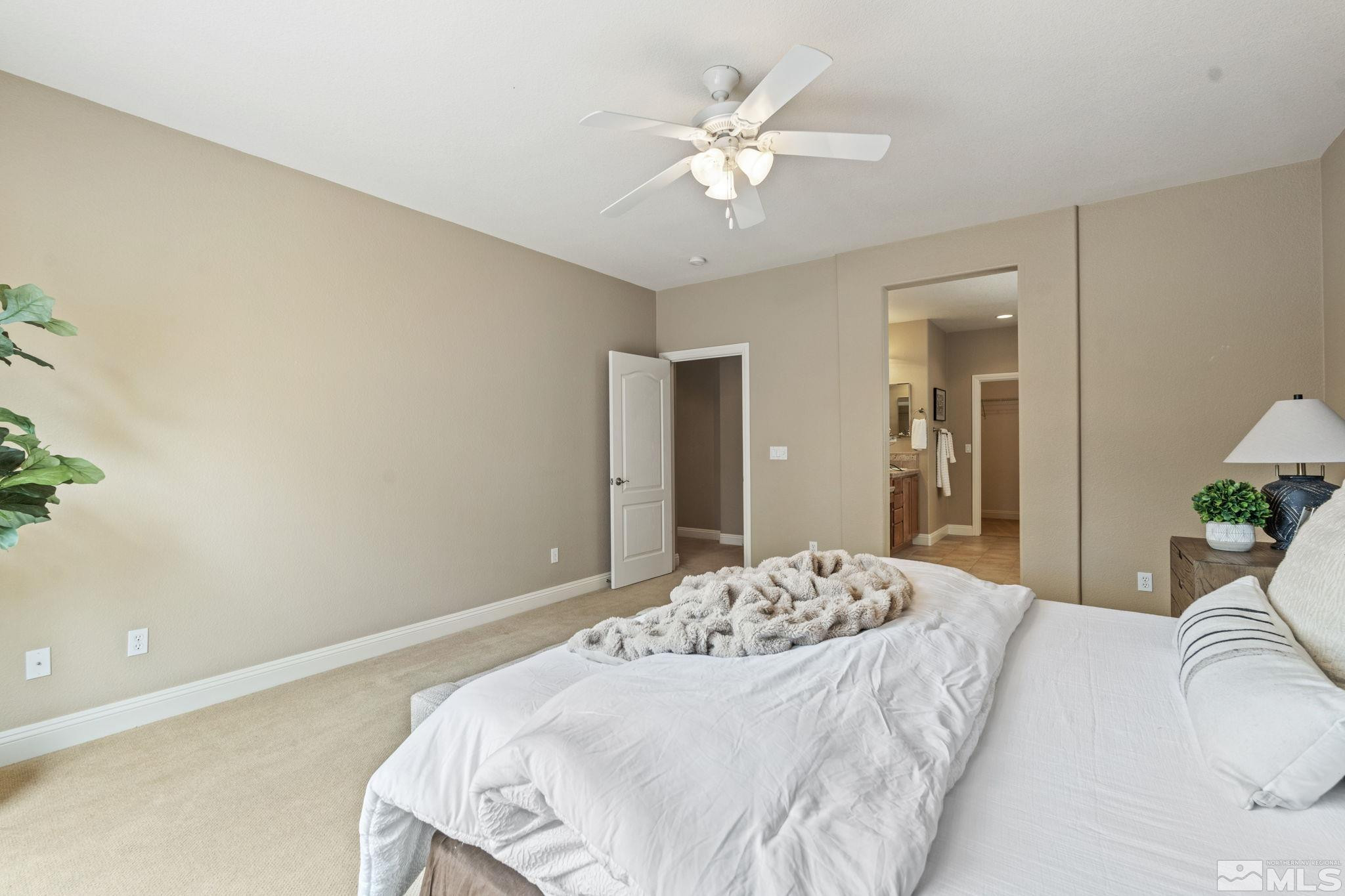 610 Aberdeen Court Reno, NV 89521 - Photo 23 of 40 a bedroom with a large bed and a chandelier