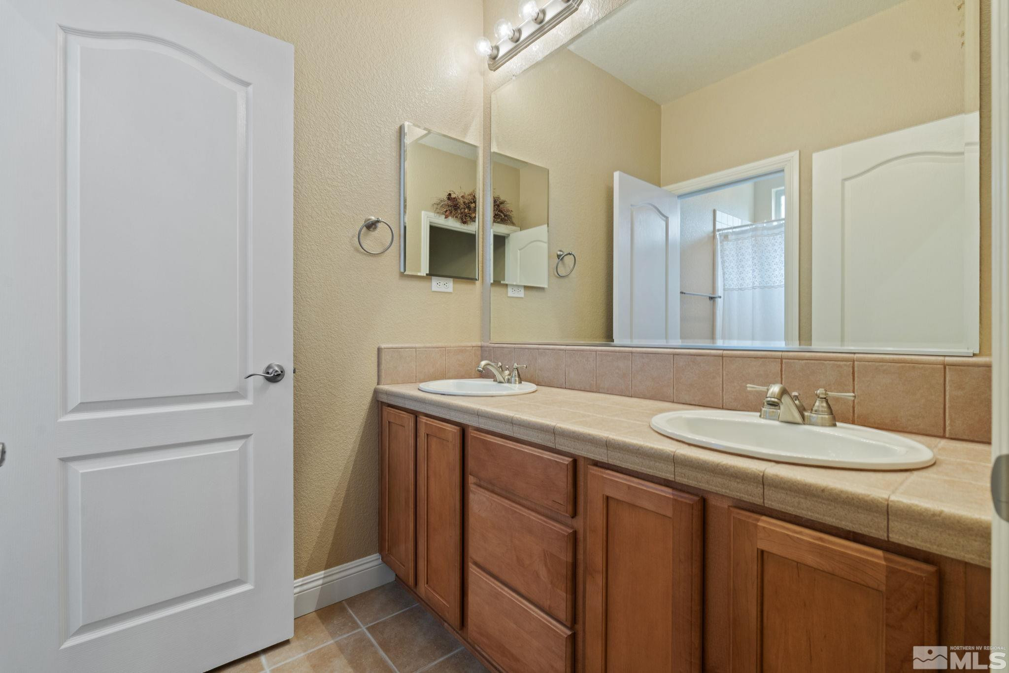 610 Aberdeen Court Reno, NV 89521 - Photo 26 of 40 a bathroom with a sink and a mirror