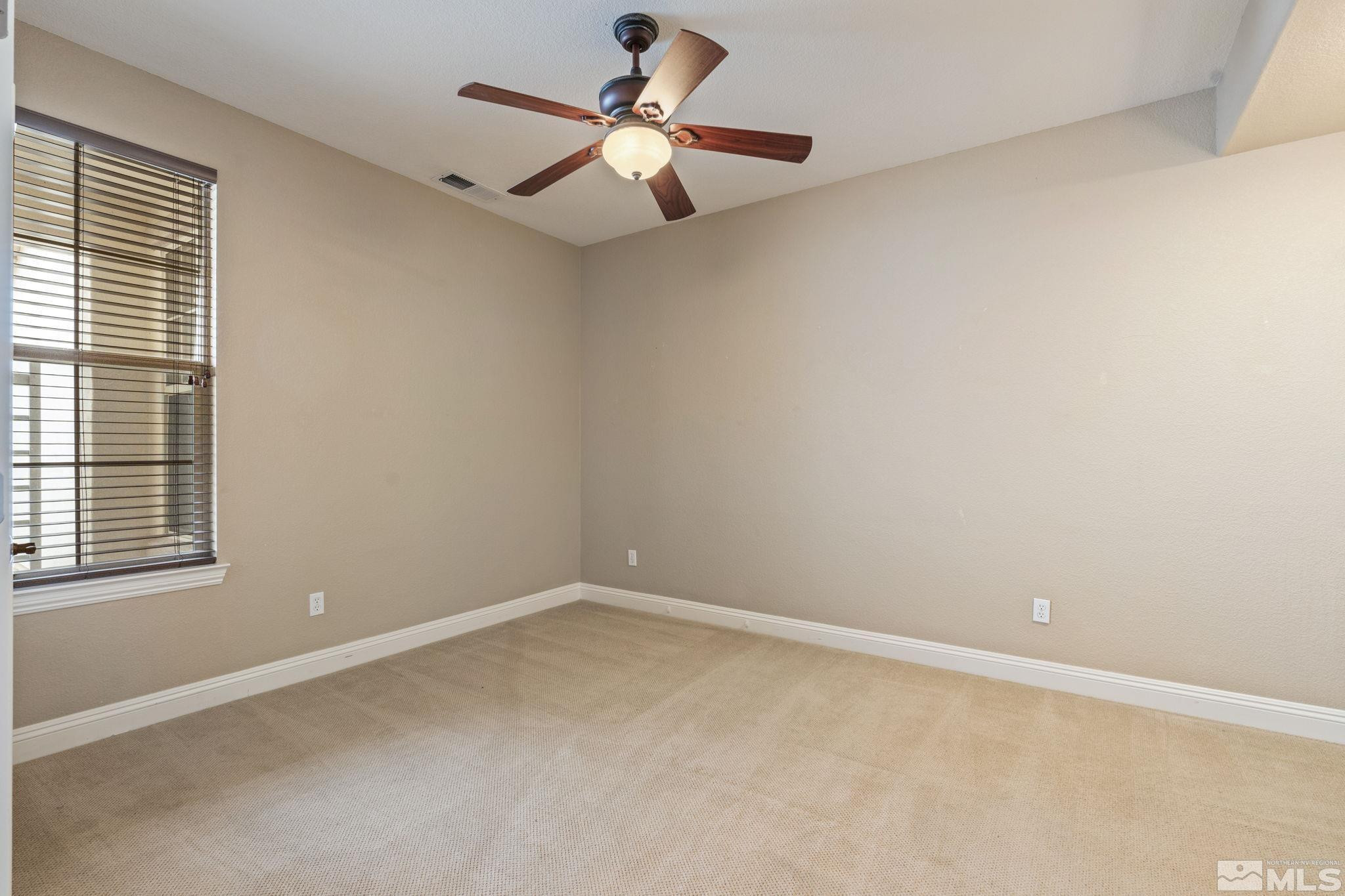610 Aberdeen Court Reno, NV 89521 - Photo 33 of 40 an empty room with a window and a fan