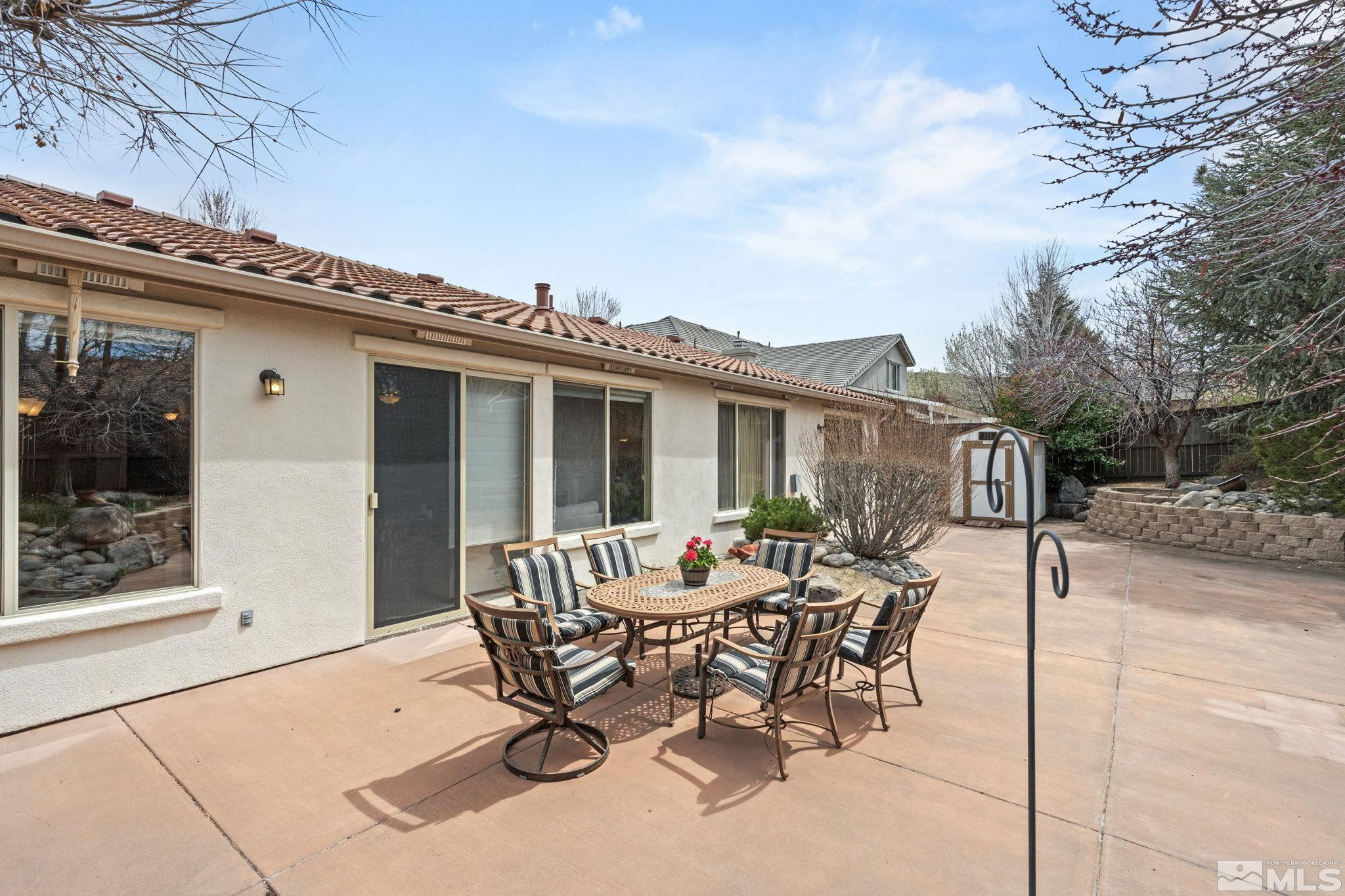610 Aberdeen Court Reno, NV 89521 - Photo 39 of 40 a patio with a table and chairs and potted plants