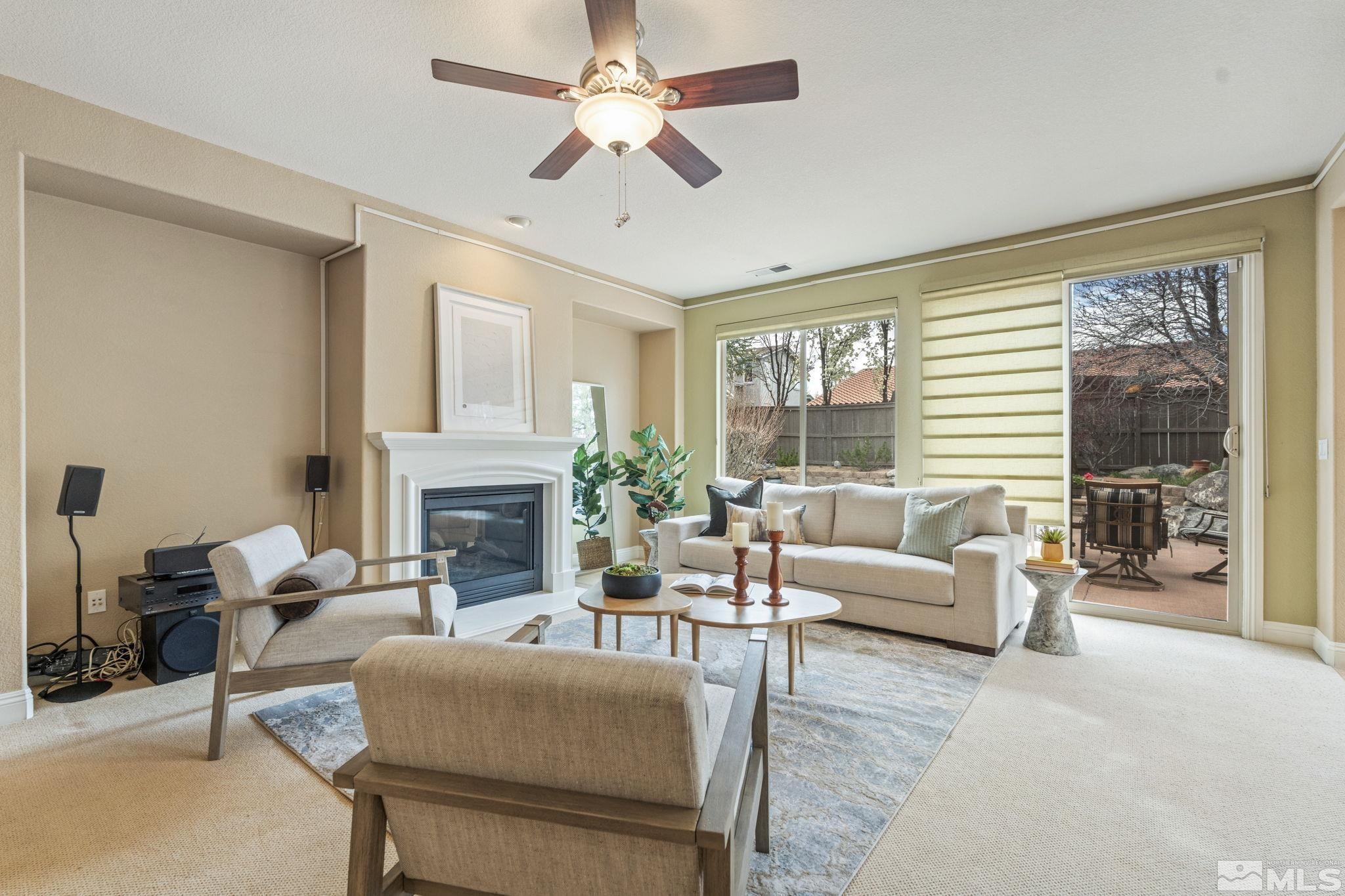 610 Aberdeen Court Reno, NV 89521 - Photo 4 of 40 a living room with furniture a fireplace and a large window