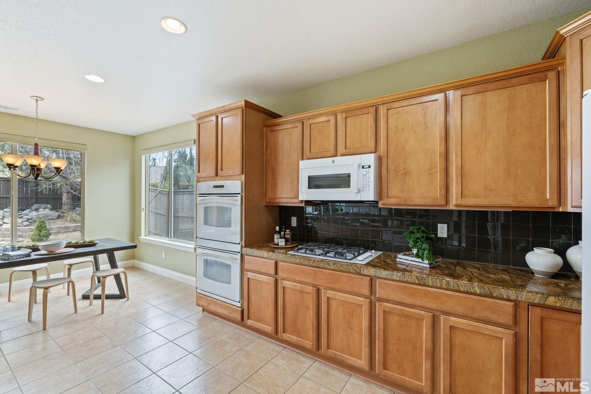 610 Aberdeen Court Reno, NV 89521 - Photo 7 of 40 a kitchen with stainless steel appliances a stove sink and cabinets