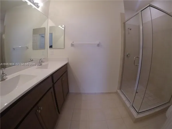 a bathroom with a double vanity sink and mirror