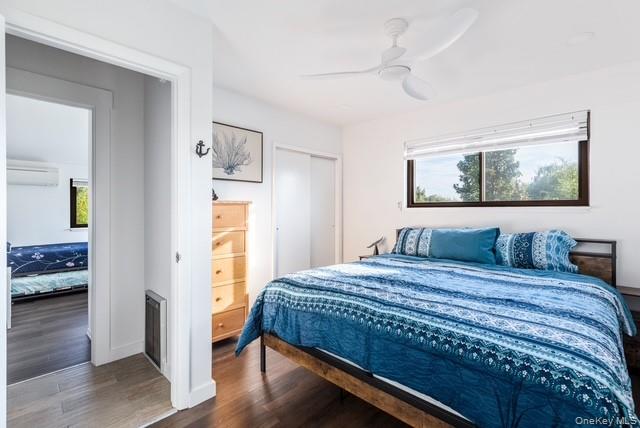 294 Wilmot Road Ocean Beach, NY 11770 - Photo 11 of 38 a bedroom with a bed and a painting on the wall