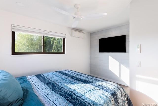 294 Wilmot Road Ocean Beach, NY 11770 - Photo 12 of 38 a bedroom with a bed and a flat screen tv