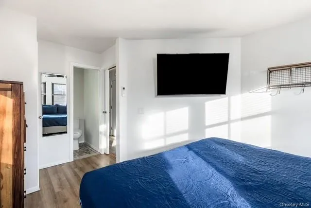 a living room with a flat screen tv and a refrigerator