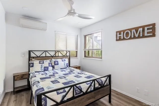 a bed sitting in a bedroom next to a window with wooden floor