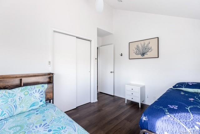 294 Wilmot Road Ocean Beach, NY 11770 - Photo 18 of 38 a view of a bedroom with wooden floor and hallway
