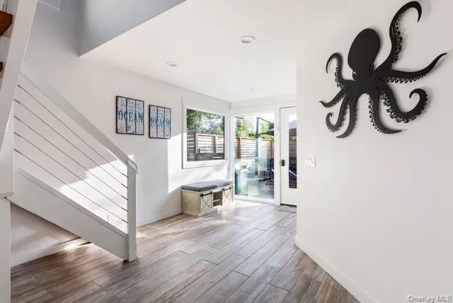 a dining room with wooden floor and furniture