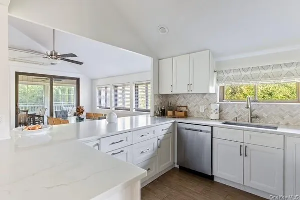 a kitchen with sink refrigerator and window