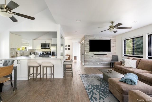 294 Wilmot Road Ocean Beach, NY 11770 - Photo 5 of 38 a living room with furniture kitchen view and a flat screen tv