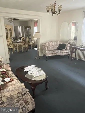 a living room with a couch and chandelier