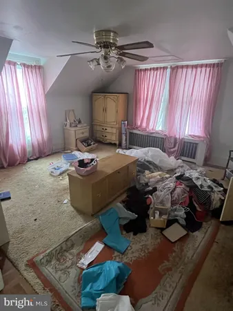 a bedroom with furniture and a window