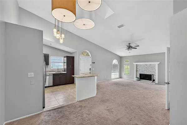 a view of an empty room with a fireplace