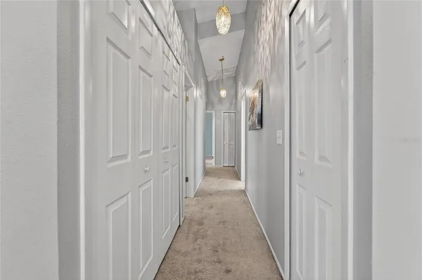 an empty room with ceiling fan and window