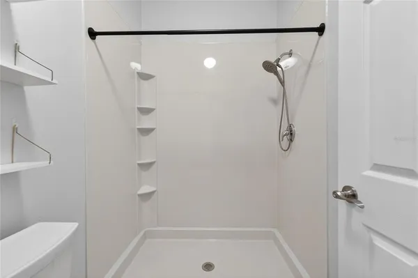 a bathroom with a bathtub sink vanity mirror and toilet