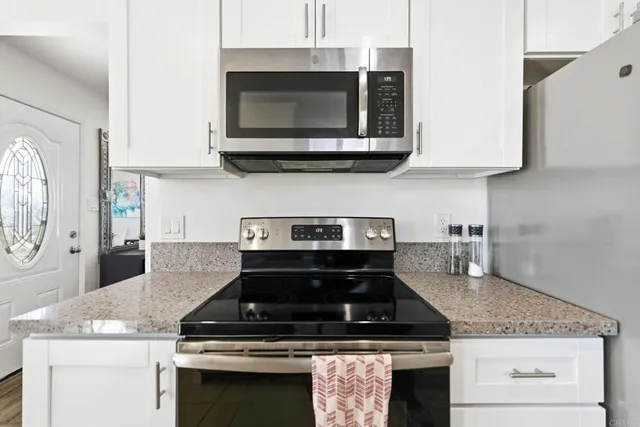 a stove top oven sitting inside of a kitchen