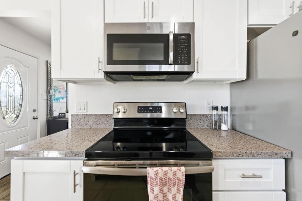 3560 Santa Maria Street Oceanside, CA 92056 - Photo 14 of 40 a stove top oven sitting inside of a kitchen