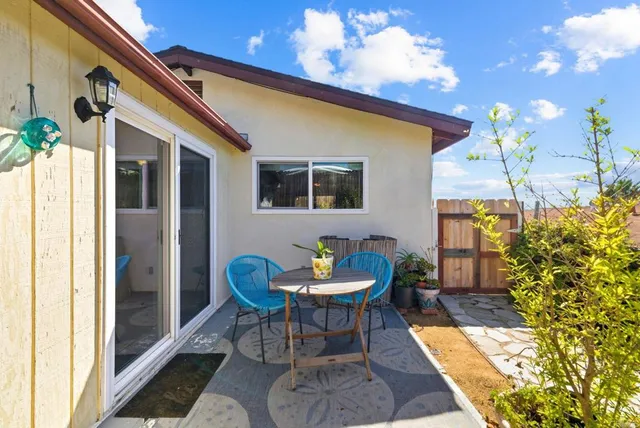 a view of a patio with table and chairs and potted plants