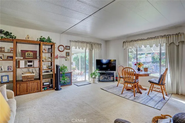 a view of a livingroom with workspace and a window