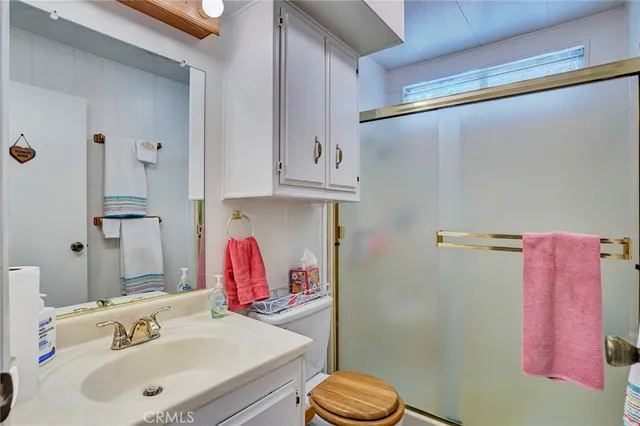 a bathroom with a sink vanity mirror and toilet