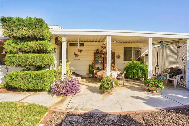 a view of a patio with a table and chairs and potted plants