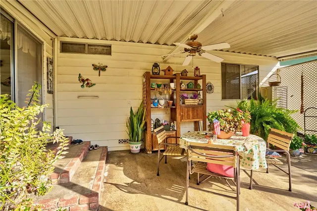 a view of a backyard with plants and patio
