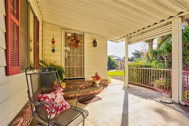 a balcony with furniture and large windows