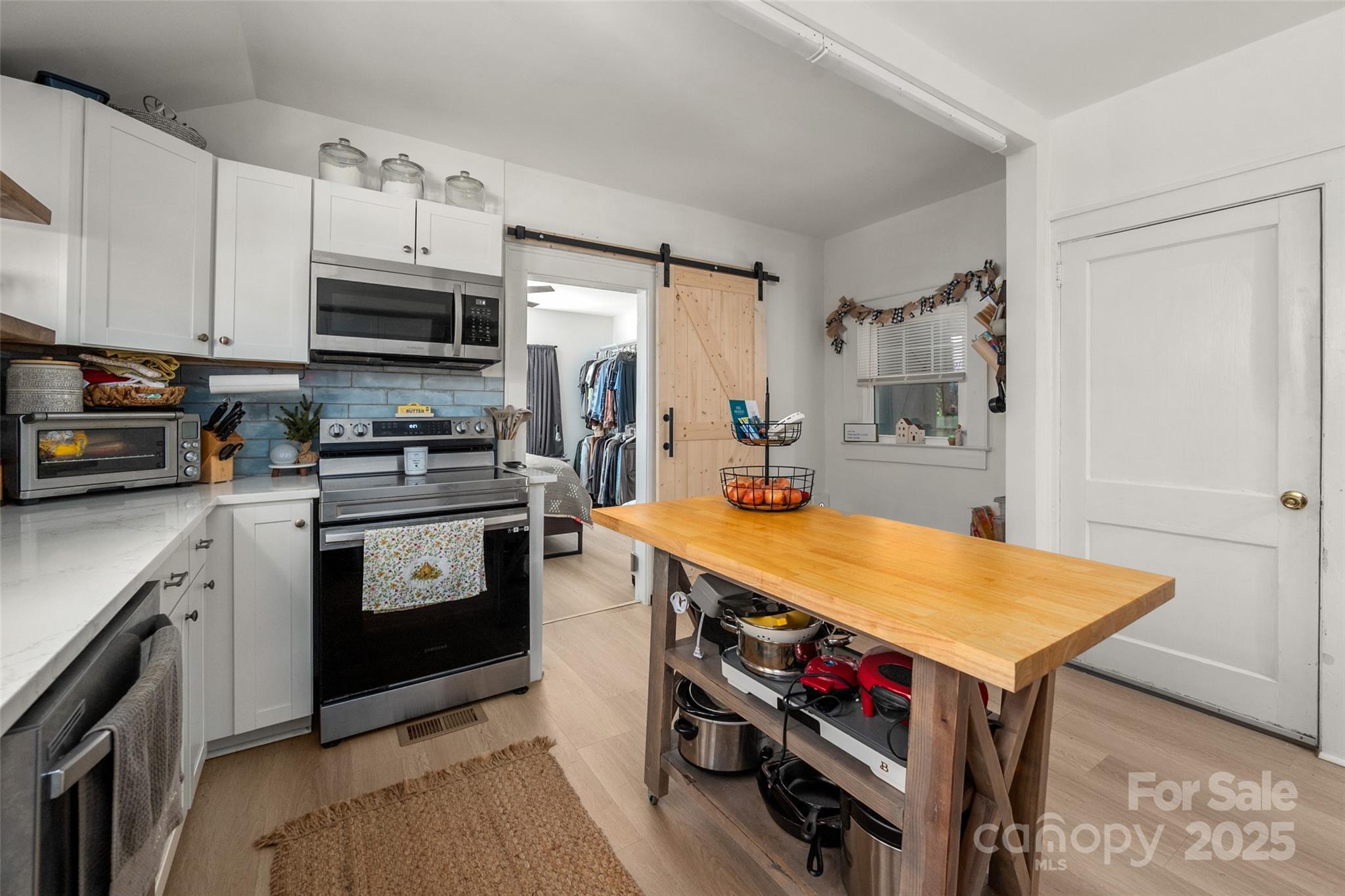 900 Chesterfield Avenue Lancaster, SC 29720 - Photo 15 of 37 a kitchen with stainless steel appliances a stove a sink and a refrigerator