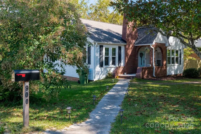 a view of a house with backyard and a tree