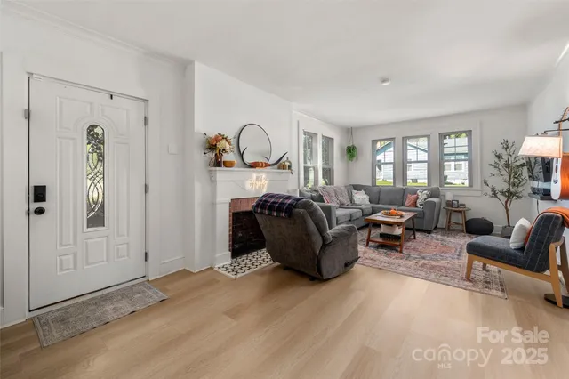 a living room with furniture a ceiling fan and a window