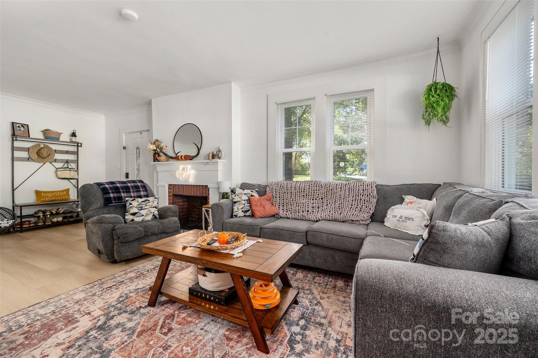 900 Chesterfield Avenue Lancaster, SC 29720 - Photo 8 of 37 a living room with furniture a fireplace a rug and a window