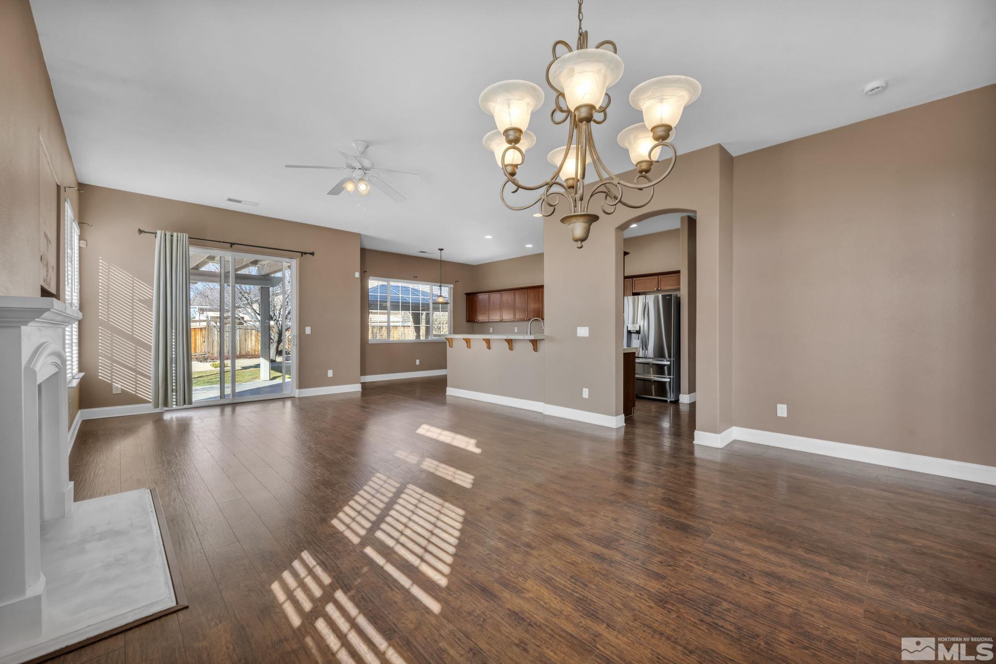 7301 Lacerta Drive Sparks, NV 89436 - Photo 15 of 39 a view of a livingroom with a furniture wooden floor and chandelier
