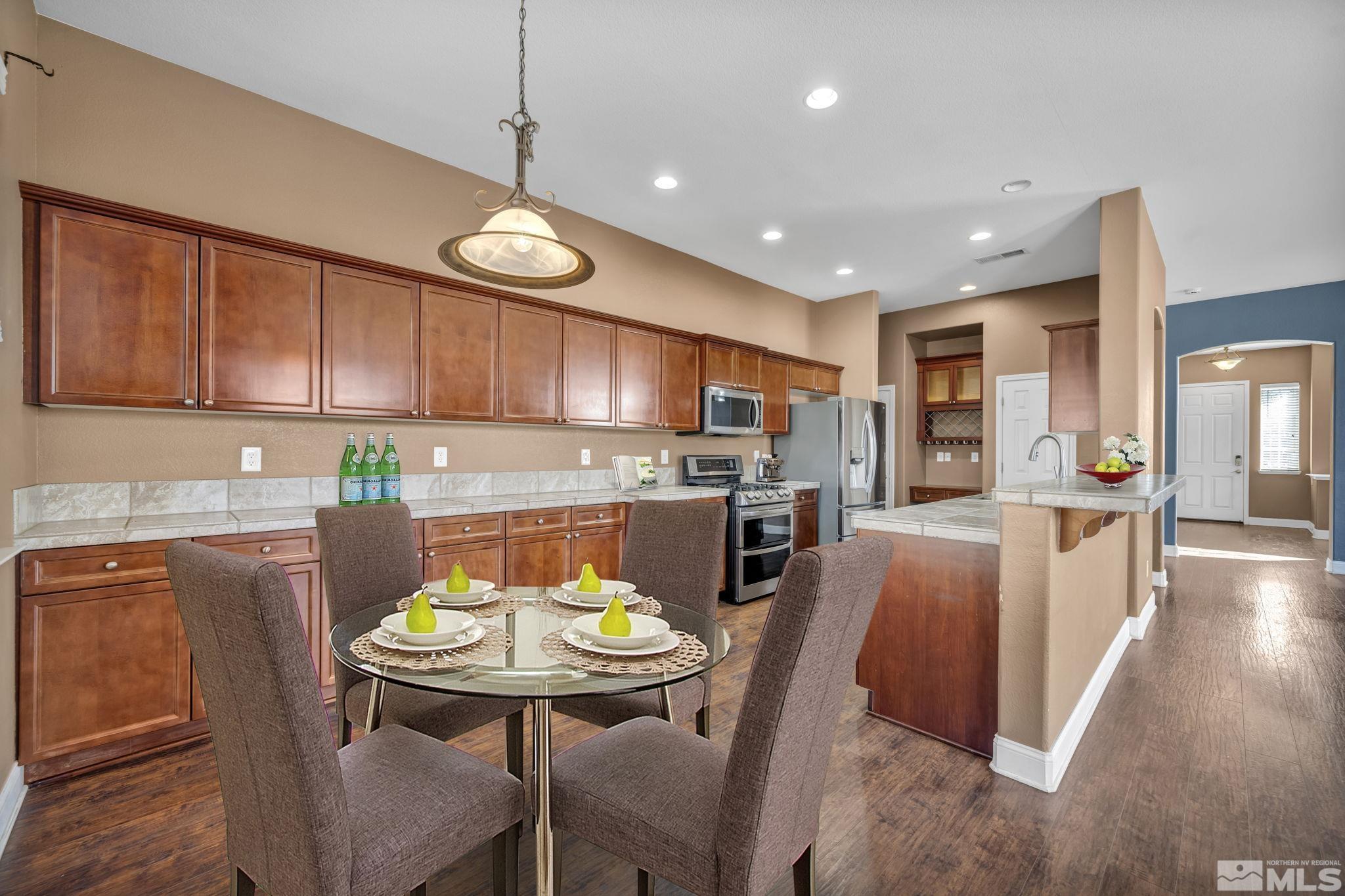 7301 Lacerta Drive Sparks, NV 89436 - Photo 19 of 39 a view of kitchen with dining table and chairs