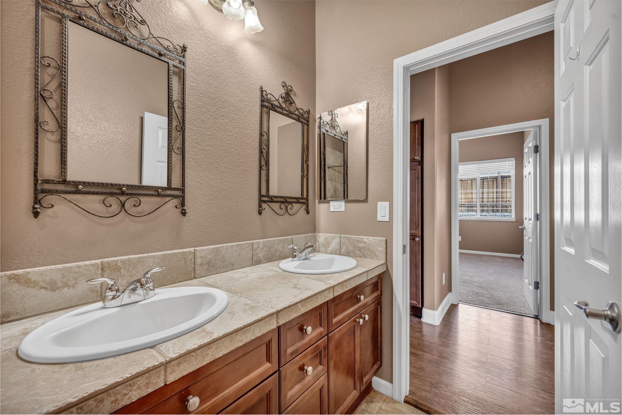 7301 Lacerta Drive Sparks, NV 89436 - Photo 32 of 39 a bathroom with double vanity sinks and a mirror