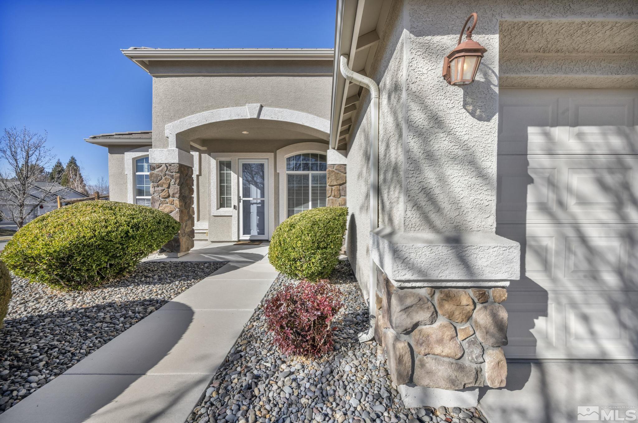 7301 Lacerta Drive Sparks, NV 89436 - Photo 5 of 39 a front view of a house with garden