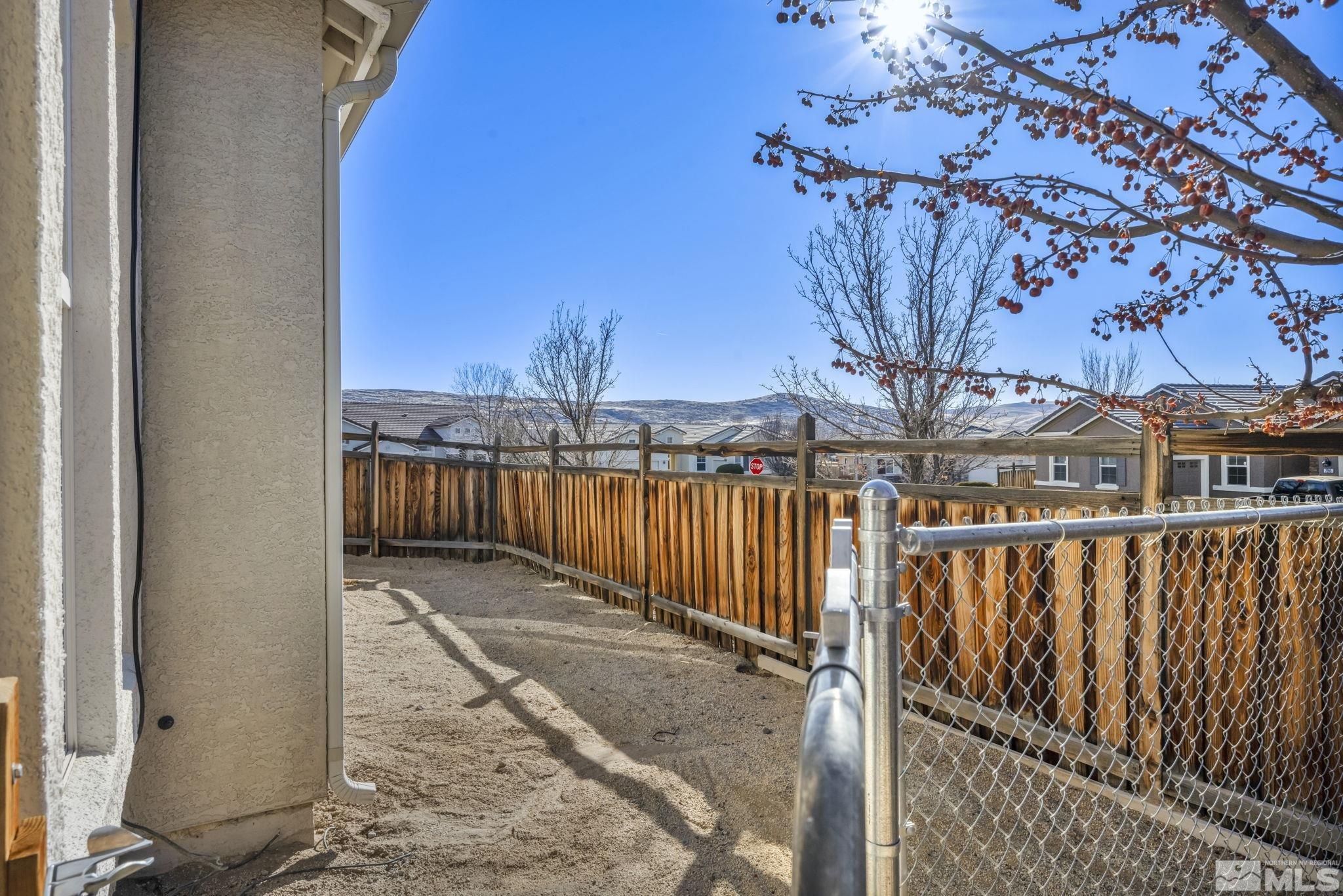 7301 Lacerta Drive Sparks, NV 89436 - Photo 9 of 39 a view of a pathway with a wrought fence