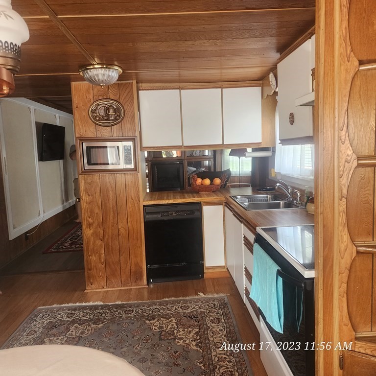 22 Windbrook Drive Auburn, MA 01501 - Photo 17 of 19 a kitchen with stainless steel appliances granite countertop a stove a sink and a microwave