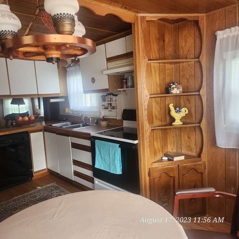 22 Windbrook Drive Auburn, MA 01501 - Photo 18 of 19 a kitchen with stainless steel appliances granite countertop a refrigerator a stove and a sink with wooden cabinets