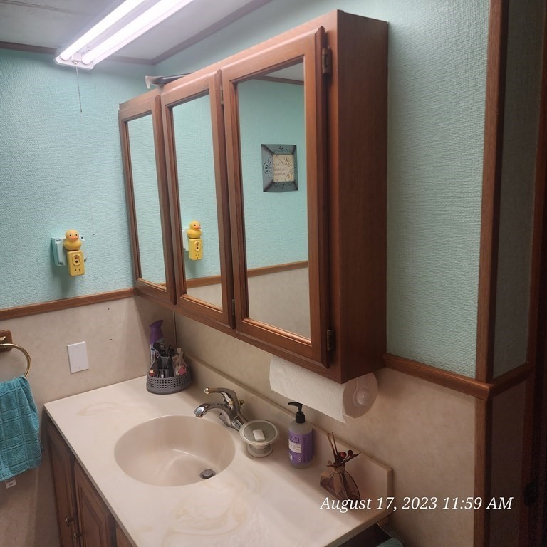 22 Windbrook Drive Auburn, MA 01501 - Photo 9 of 19 a bathroom with a sink and a mirror