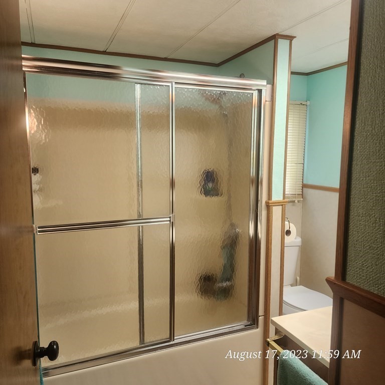 22 Windbrook Drive Auburn, MA 01501 - Photo 10 of 19 a bathroom with a glass shower door