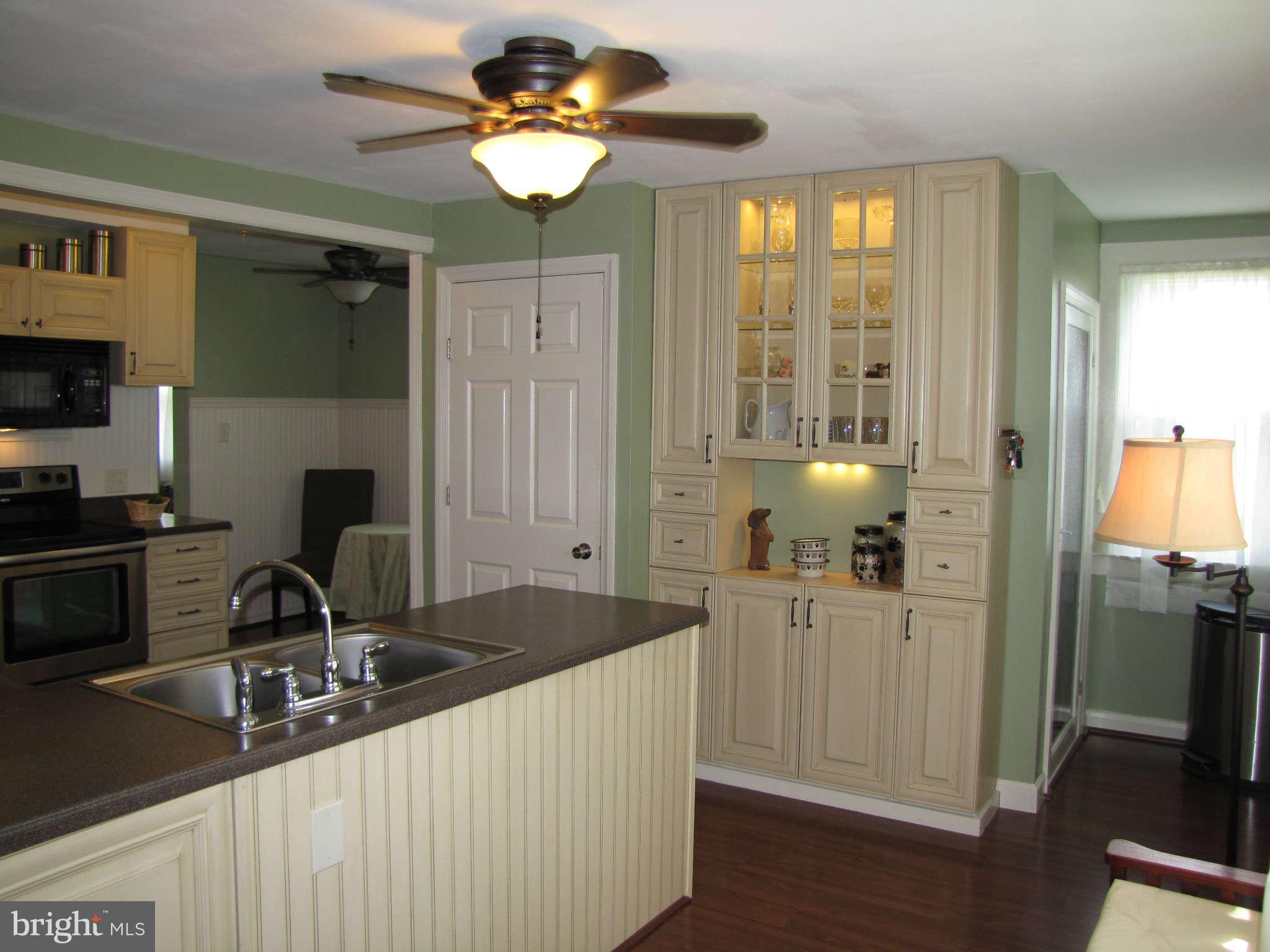 1017 Minnetonka Road Severn, MD 21144 - Photo 3 of 23 a kitchen with a sink appliances and cabinets