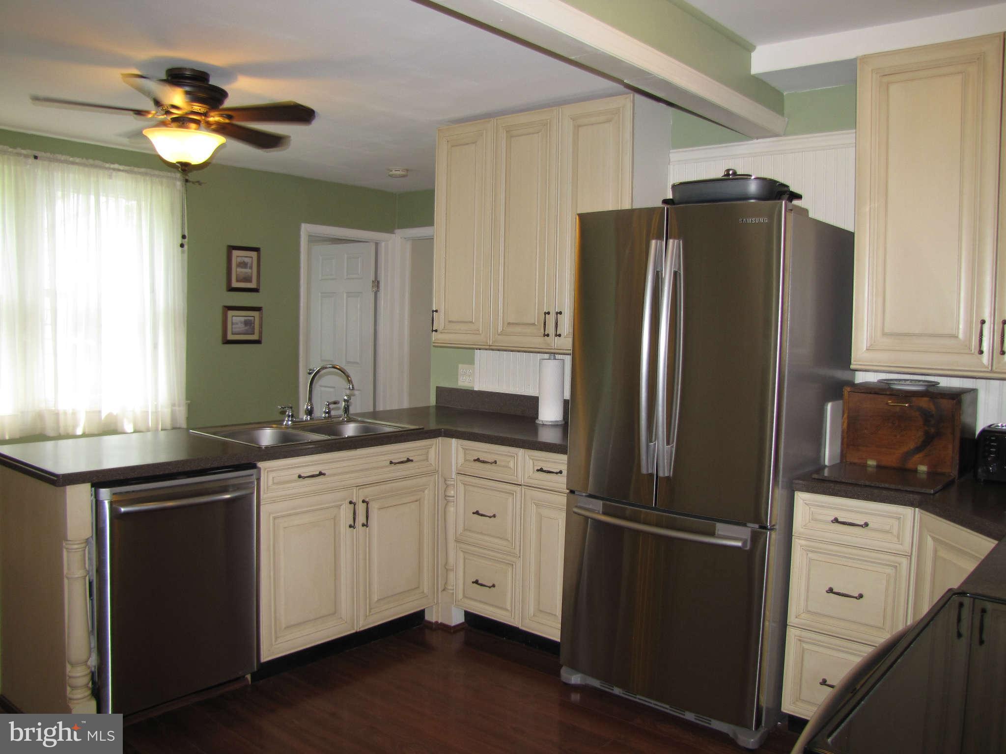 1017 Minnetonka Road Severn, MD 21144 - Photo 4 of 23 a kitchen with stainless steel appliances a refrigerator sink and microwave