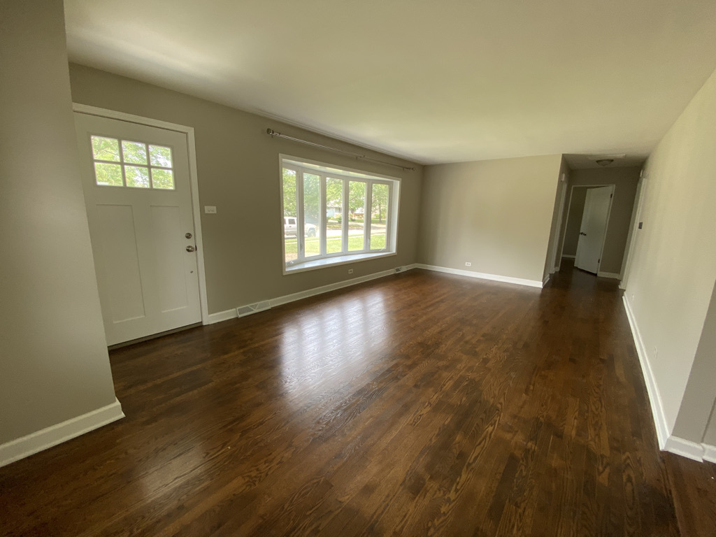 201 Pine Street Villa Park, IL 60181 - Photo 2 of 17 a view of an empty room with wooden floor and a window