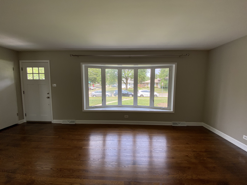 201 Pine Street Villa Park, IL 60181 - Photo 4 of 17 a view of empty room with wooden floor and fan