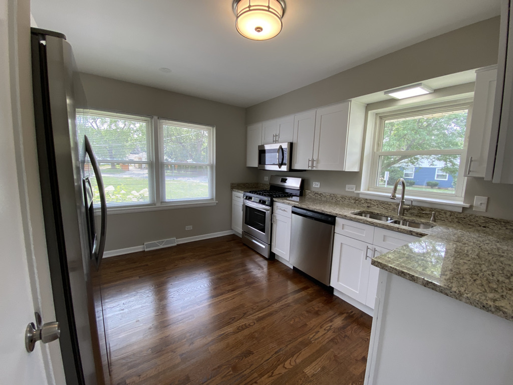 201 Pine Street Villa Park, IL 60181 - Photo 6 of 17 a kitchen with granite countertop a stove a sink and a refrigerator
